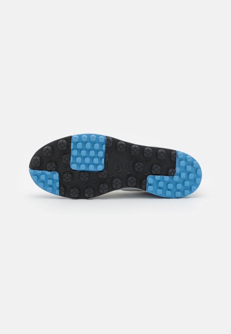 Suela de zapato de goma negra con secciones acolchadas azules y textura punteada, diseñada para tracción y durabilidad.