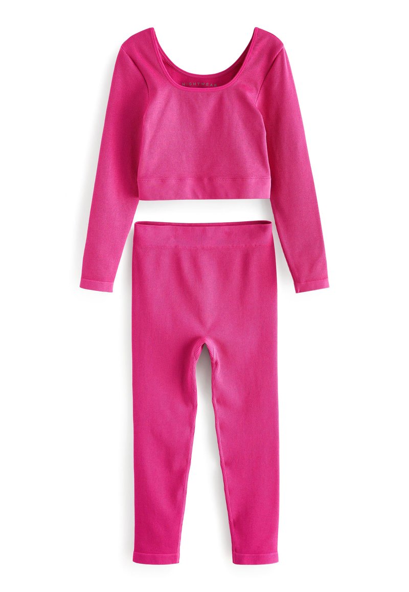 Ružový rebrovaný loungewear set obsahujúci crop top s dlhým rukávom a zodpovedajúce legíny. Mäkká textúra s priliehavým strihom a elastickým pásom.