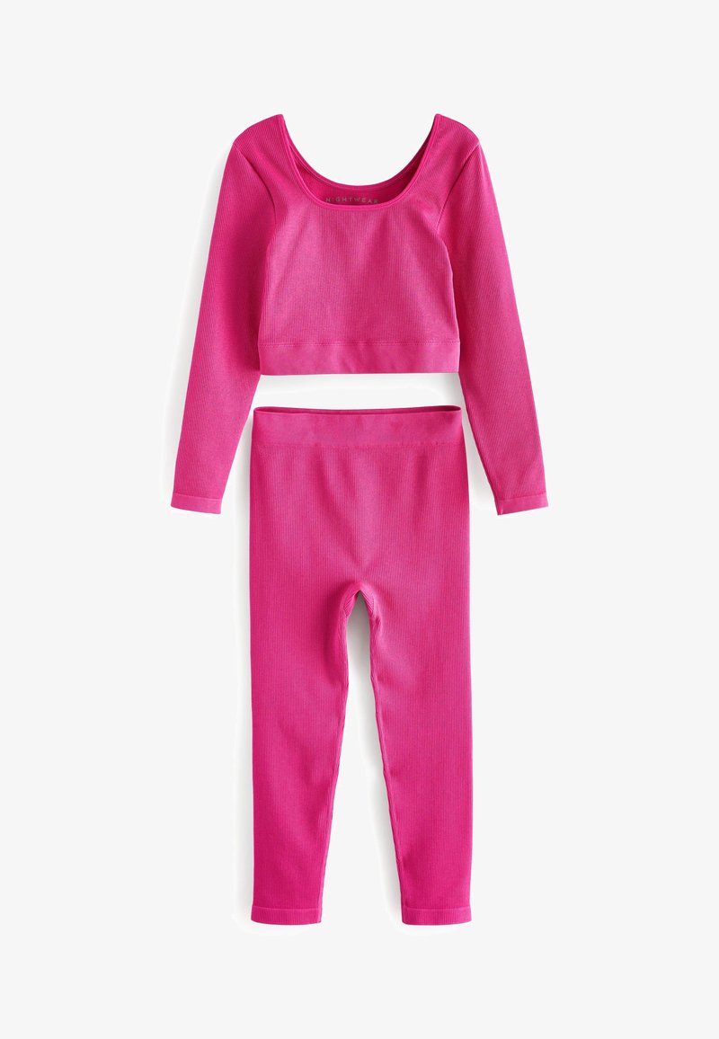 Ružový rebrovaný loungewear set obsahujúci crop top s dlhým rukávom a zodpovedajúce legíny. Mäkká textúra s priliehavým strihom a elastickým pásom.
