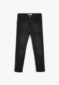 Jeans de denim negros con un corte ajustado, que cuentan con bolsillos delanteros, trabillas para el cinturón y un cierre de botón. Acabado desgastado con mínimos detalles de desgaste.