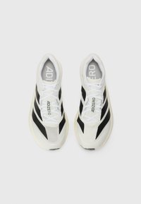 White mesh running shoes with black accents, featuring a streamlined design, rounded toe, and cushioned midsole. Laces and logo visible.