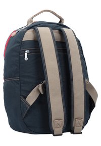 Backpack with navy fabric, beige mesh straps, and red zipper detail. Features a side zip pocket and reinforced stitching. Compact, curved shape.