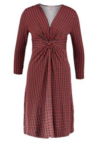 Robe à motifs rouges et noirs avec manches longues, décolleté en V et détail enroulé à l'avant. Tissu doux avec une coupe arrivant au genou.