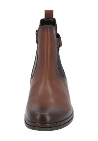 Botín de cuero marrón con paneles laterales elásticos y una lengüeta, con acabado suave y punta redonda, montado sobre una suela texturizada.