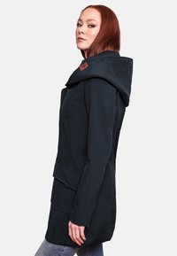 Dark navy hooded coat with a fitted design, featuring a zip closure, accent pockets, and a textured fabric. Logo detail on the hood.