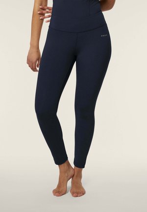Leggings blu navy con vita alta, realizzati in materiale elastico. Texture liscia, design aderente, lunghezza totale con cuciture alla caviglia e branding minimale.