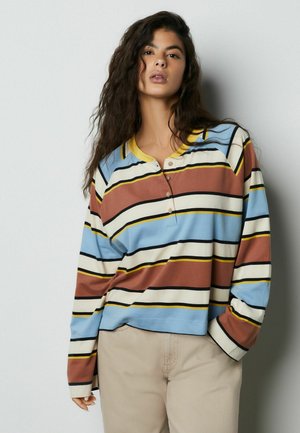 Randig tröja med långa ärmar i blått, brunt och krämfärgat med gula detaljer, med knappslå och ledig passform. Texturerat tyg.