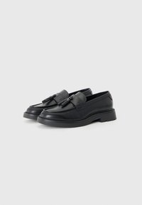Black leather loafers with a smooth finish, featuring decorative tassels, a rounded toe, and a thick rubber sole. Suitable for casual use.