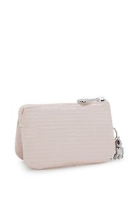 Light pink wallet made of textured fabric with a zip closure, featuring a silver charm attached to the zipper.