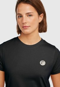 Black short-sleeve t-shirt made of smooth fabric featuring a circular logo on the chest and a classic crew neckline.