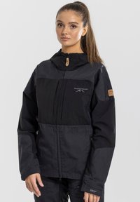 Black outdoor jacket with a zippered front, hood, contrasting fabric panels, and logo accents. Features long sleeves and a relaxed fit.