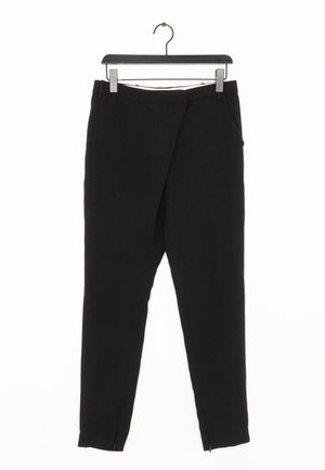 Pantalons noirs ajustés en tissu lisse, avec une coupe droite, deux poches latérales et des zips à la cheville pour un ajustement.