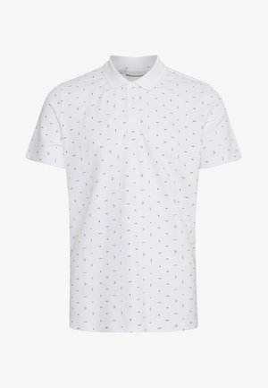 Valge polo särk, millel on musta ja halli toonidega peene korduv muster. Valmistatud hingavast kangast, klassikalise krae ja nööbiga sulgemisega.