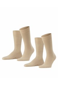 Calze beige realizzate in un materiale morbido e liscio. Presentano un design a costine nella parte superiore e una lunghezza classica da crew. Disponibili in tre paia.