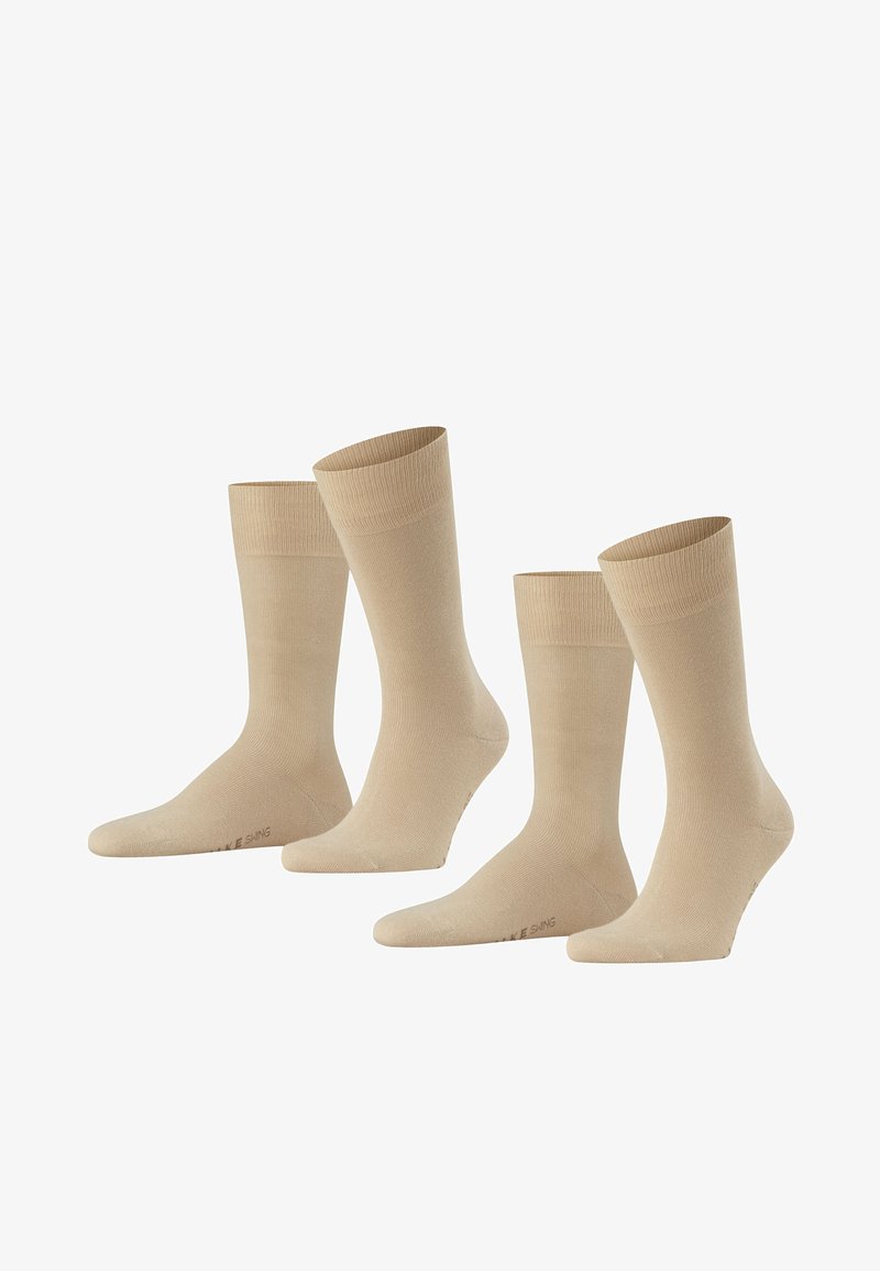 Calze beige realizzate in un materiale morbido e liscio. Presentano un design a costine nella parte superiore e una lunghezza classica da crew. Disponibili in tre paia.