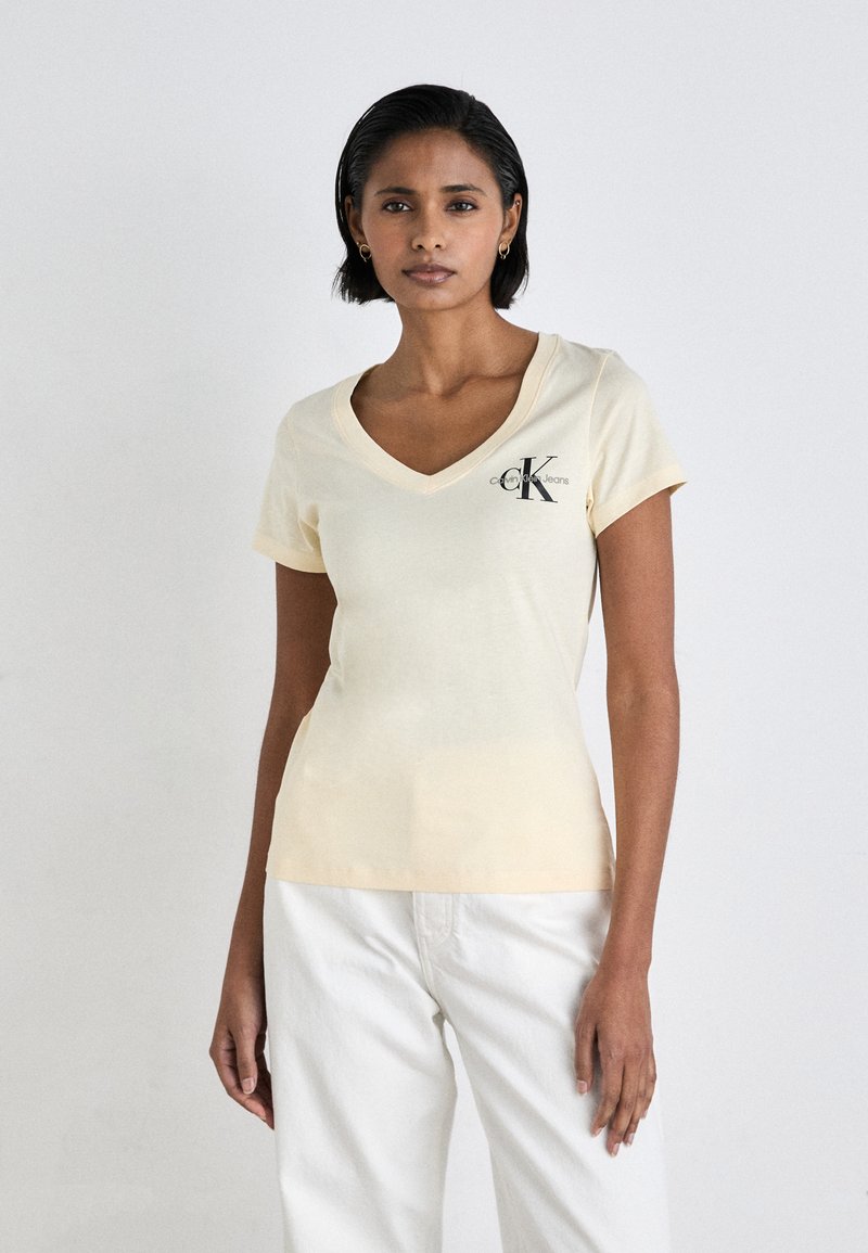 Calvin Klein Jeans MONOLOGO V NECK TEE - Triko s potiskem - vanilla