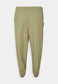 Ljust olivgrön avslappnad byxa med elastisk midja och muddar, med sidostrickor och en avslappnad passform.