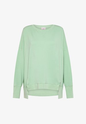Jasnozielona bluza wykonana z bawełnianej mieszanki. Posiada okrągły dekolt, opuszczone ramiona, boczne rozcięcia oraz luźny krój z zakończeniami na ściągacze.