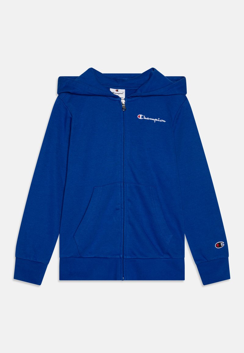 Hoodie zippé bleu en tissu doux, avec une poche frontale, une capuche et un petit logo brodé sur la poitrine et la manche.