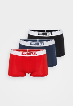 Three pairs of boxer shorts: red, navy, and black. Each features a white elastic waistband with "DIESEL" logo. Soft cotton material, snug fit.