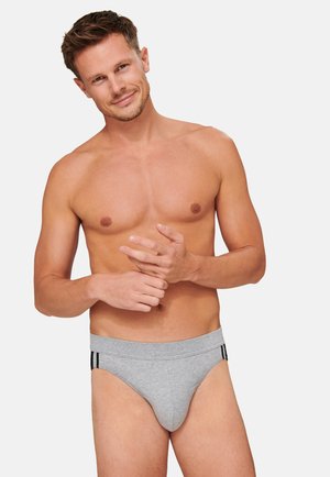 Mutande grigie in cotone con una fascia elastica alta che presenta strisce nere. Il materiale appare morbido e il design è di tipo fitted a vita bassa.