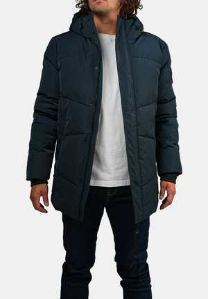 Veste d'hiver matelassée bleu foncé avec capuche, fermeture éclair à l'avant et boutons-pression. Comprend des poignets côtelés et une texture lisse et brillante.