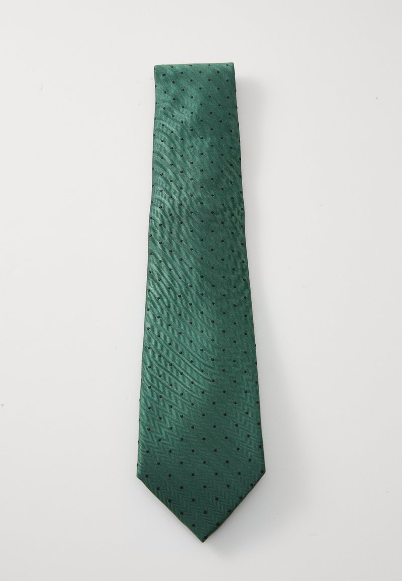 Green silk tie with a textured herringbone pattern, featuring small black polka dots, and a pointed end. Smooth finish, medium width.