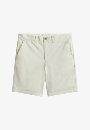 Hellbeige Baumwollshorts mit Gürtelschlaufen, seitlichen Taschen, Knopfverschluss und einem kleinen sichtbaren Markenetikett im inneren Bund.