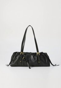 Sac à main en cuir noir avec sommet froncé, poignées longues, ferrures dorées, accent circulaire et liens latéraux pour fermeture ajustable.