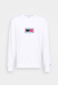 Vit crewneck sweatshirt i bomull med en flerfärgad broderad logotyp på bröstet. Långa ärmar med ribbad mudd.