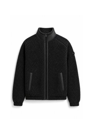 Veste polaire noire zippée avec col montant, deux poches frontales verticales, poignets élastiques et tissu texturé.