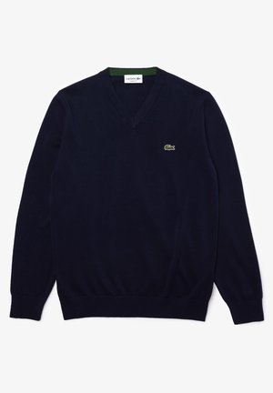 Dunkelblaues V-Ausschnitt Sweatshirt aus weichem Material, mit gerippten Bündchen und Saum, sowie einem kleinen grünen Logo auf der Brust.