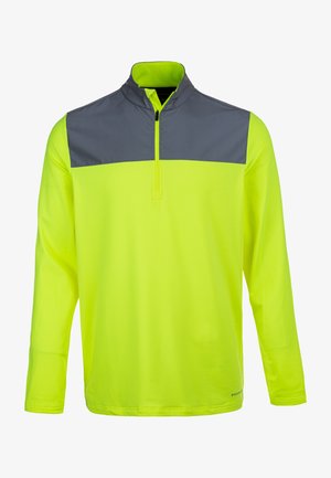 Langærmet pullover i lys gul med en mørkegrå yoke. Har en kvart lynlås og en let, glat tekstur.