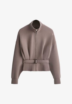 Taupe long-sleeve jacket with high collar, front zipper, and matching fabric belt with buckle at the waist.