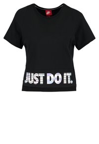 Black Nike short-sleeve cropped shirt with reflective "JUST DO IT." text across the front hem and a red Nike logo tag inside the collar.