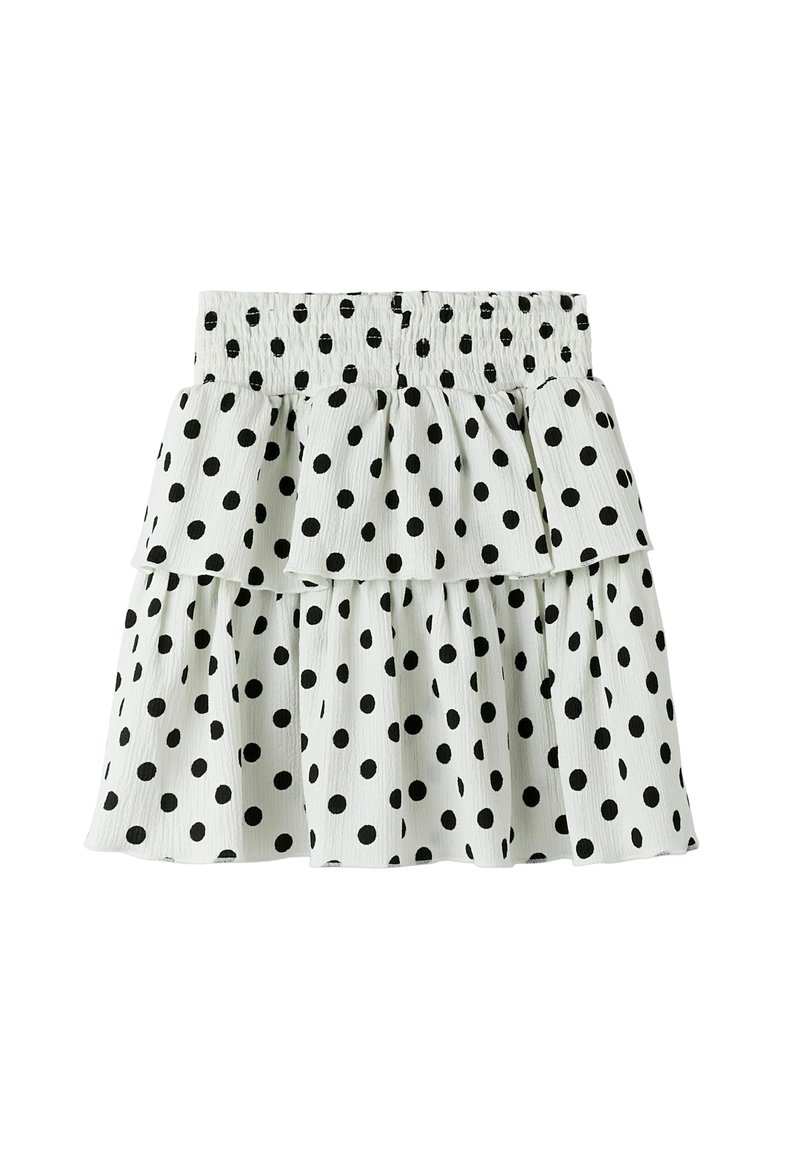 Svart kjol med prickar, gjord av lättviktsmaterial. Har ett lager-på-lager, volangdesign och ett elastiskt midjeband för komfort.
