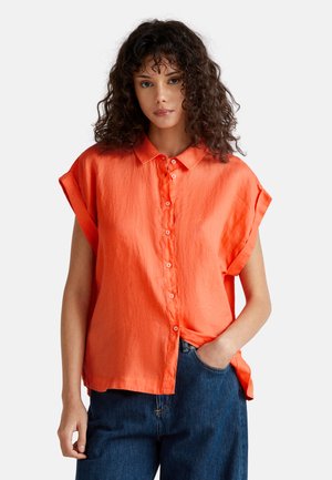 Orange linen short-sleeve shirt with a classic collar and button-down front. Features relaxed fit and side slit details.