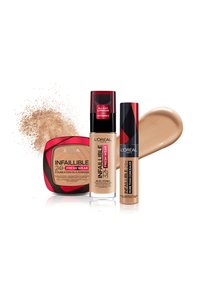 Tre L'Oréal sminkprodukter: en kompakt foundation i en svart och röd behållare, en flytande foundation med SPF i en glasflaska, och en concealer i ett rör.