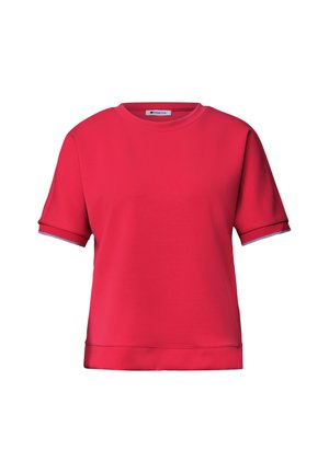 T-shirt rouge à manches courtes avec col rond, poignets repliés et ourlet droit, présenté sur un fond blanc.