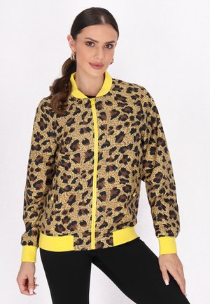 Brun og gul leopardprint bomberjakke med lynlås foran, ribbede manchetter og kant. Glat stof med tydelige mønstre.