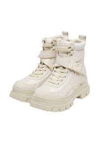 Pair of chunky off-white high-top boots with thick soles, laces, and branded adjustable straps reading "BUFFALO" across ankles.