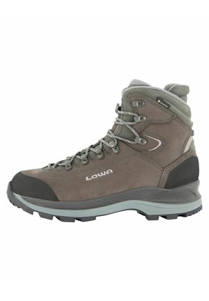 Hiking boot made of brown suede with gray accents. Features durable rubber sole, metal lace hooks, and padded ankle support.