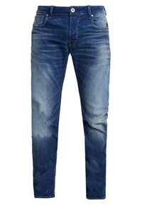 Mörkblå denimjeans med en blekt tvätt, klassisk femficksdesign och kontrasterande sömmar. Har en dragkedja och bälteshällor.