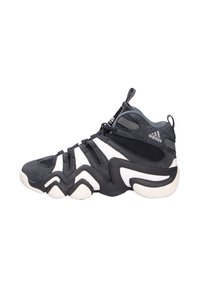 Schwarz-weißer High-Top-Sportschuh mit einer strukturierten Oberseite, geformter Sohle und markantem Zickzackmuster. Mit Branding auf der Zunge.