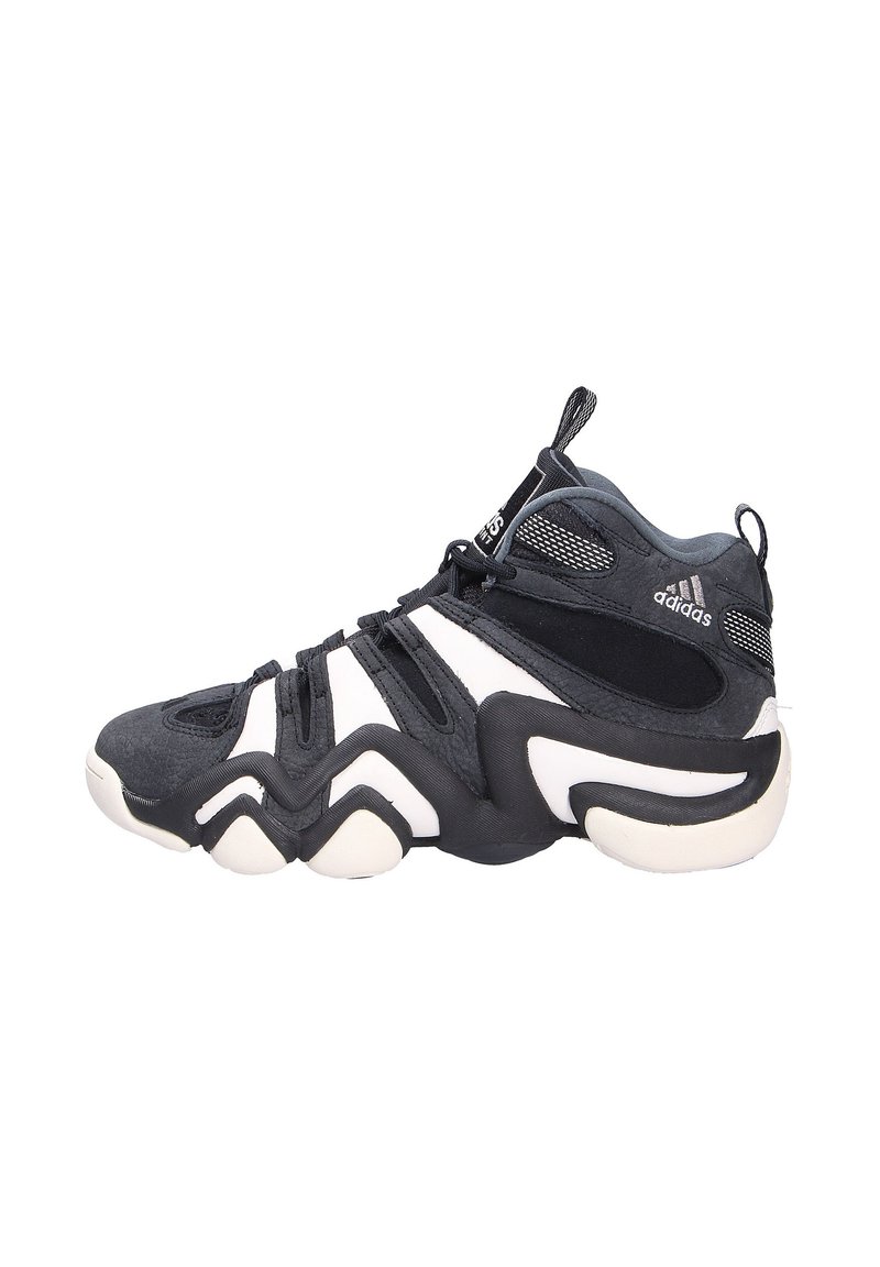 Schwarz-weißer High-Top-Sportschuh mit einer strukturierten Oberseite, geformter Sohle und markantem Zickzackmuster. Mit Branding auf der Zunge.