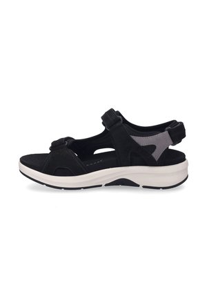 Black sandal with adjustable straps, suede and mesh materials, cushioned footbed, and contrasting white sole featuring textured grip.