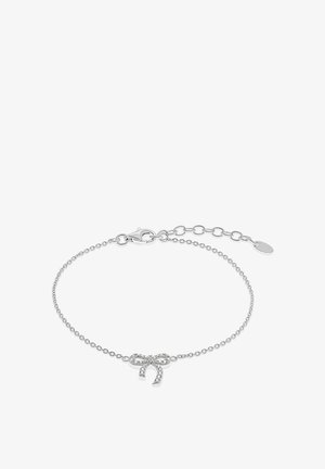 Bracelet en chaîne argentée avec un charm en forme de nœud et des accents en pierres précieuses transparentes. Dispose d'un fermoir mousqueton et d'une longueur de chaîne ajustable.