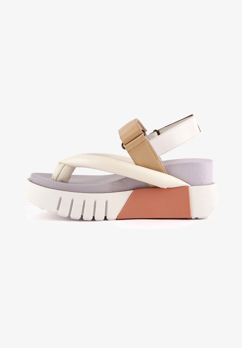 Sandale à plateforme épaisse avec des brides rembourrées blanches et beiges, boucle réglable à la cheville, semelle intérieure violette et semelle épaisse blanche et orange.