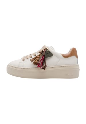 White platform sneaker with beige sole and heel accent, beige laces, and decorative tassels and charms attached to the laces.