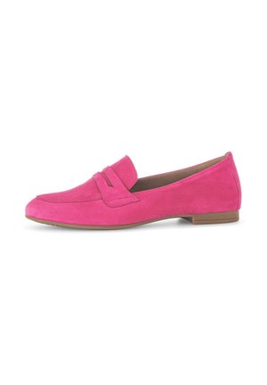 Pink suede loafers with a rounded toe and a decorative band across the front, featuring a flat, brown rubber sole.